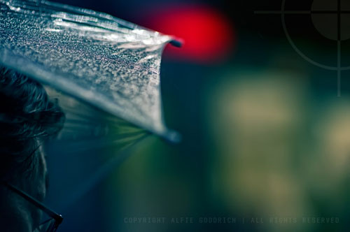 Man In Glasses Waits At The Station With Umbrella